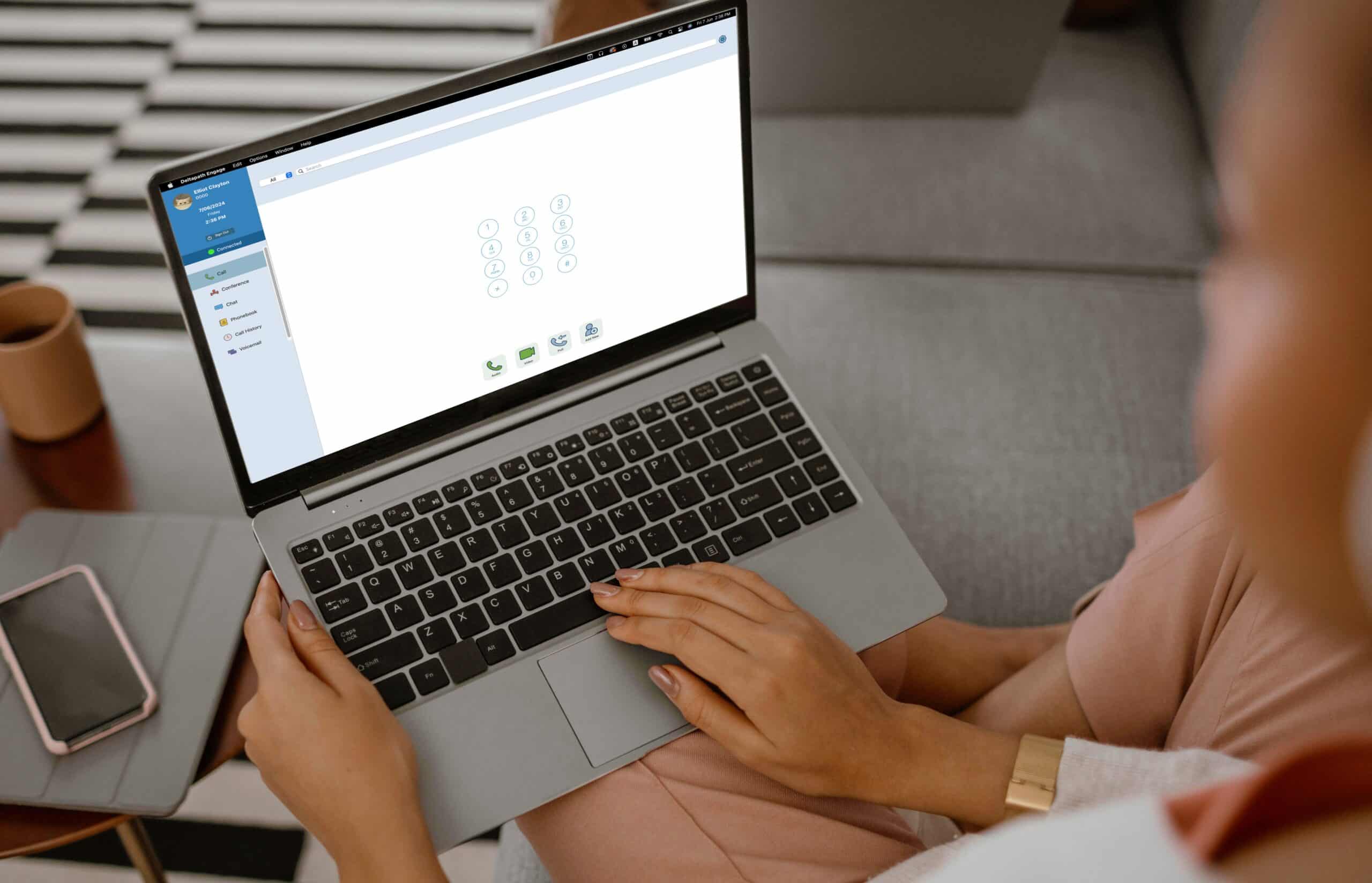 A woman using soft phone on MacBook