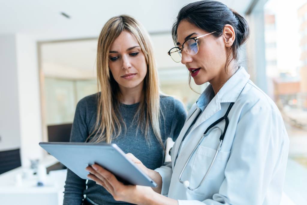 A patient looking at a doctor’s tablet.