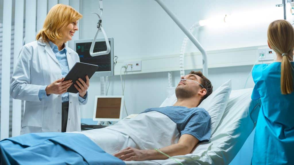 Friendly female doctor talking to a patient with tablet in hand.